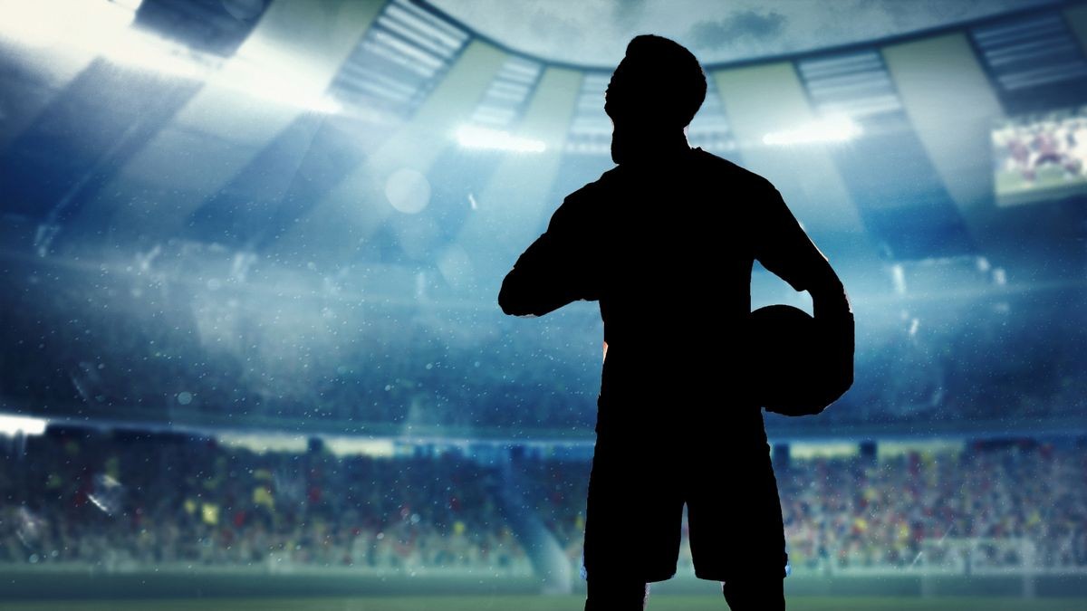 1-african-american-football-or-soccer-player-at-stadium-in-flashlights-motion-action-activity-co-1707103885.jpg
