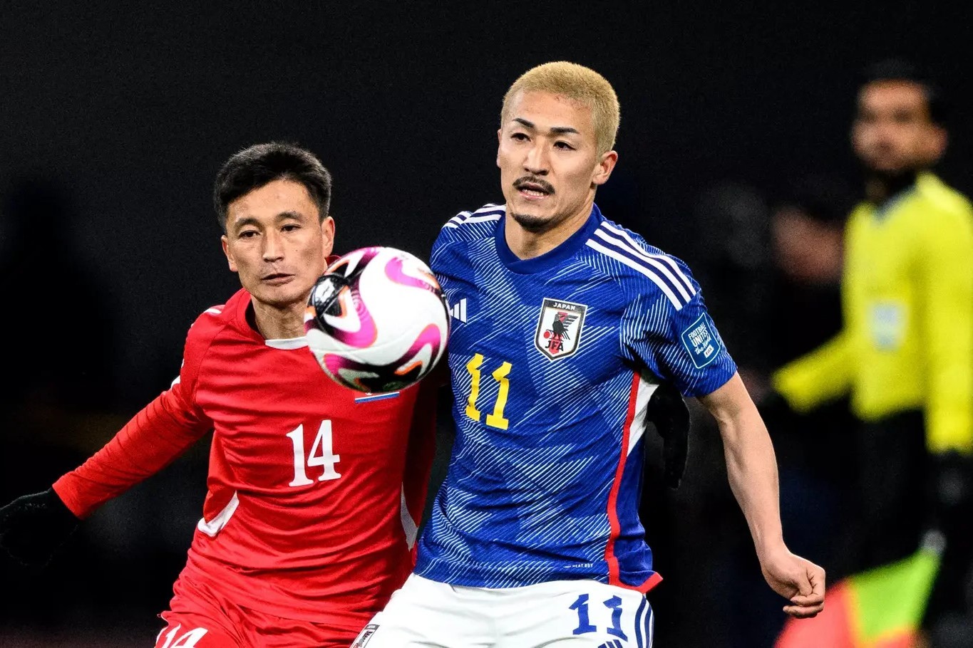 korea-dpr-s-defender-choe-ok-chol-and-japan-s-daizen-maeda-r-compete-for-the-ball-1-1711276807.jpg